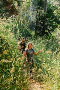 active young couple spending time in forest on sunny day